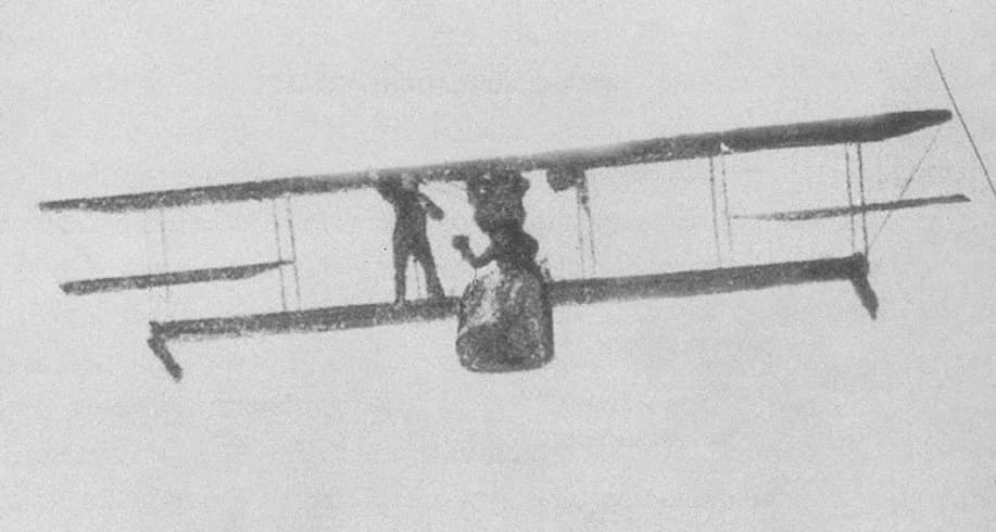 Lawrence Sperry demonstrating the gyroscopic stabilizer on a biplane, with Émile Cachin standing on the wing.