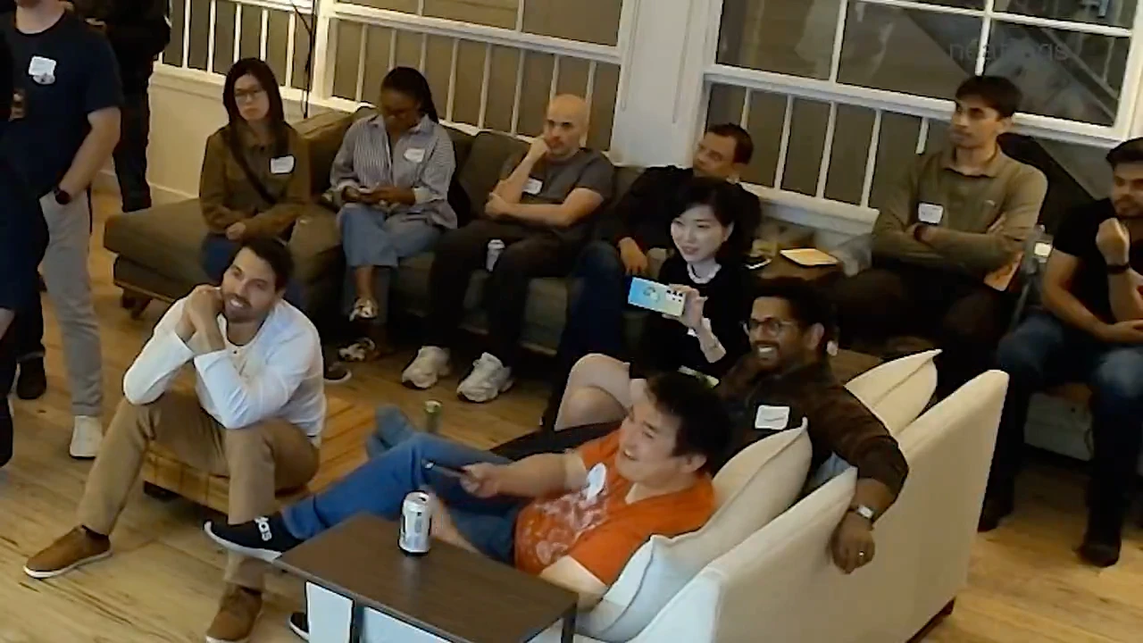 Attendees watching and discussing a demo at the San Francisco gathering